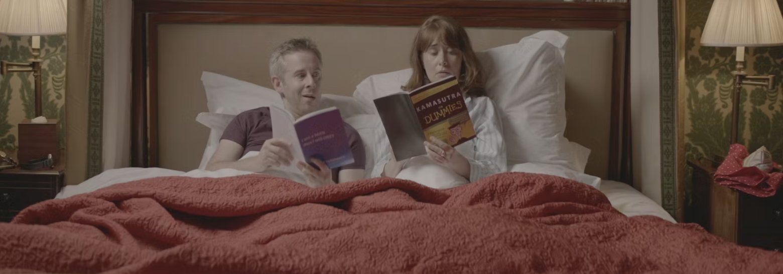 Film still: Rupert and Lisa reading in bed