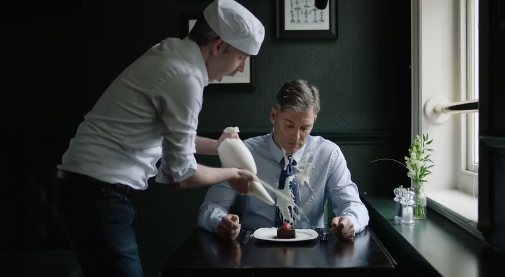 Film still: an awkward moment in a restaurant